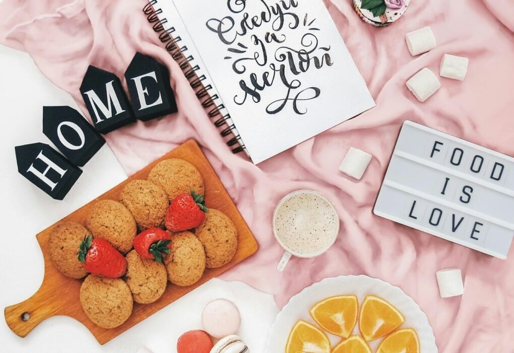 Cookies, fruit, and marshmallows with "food is love" sign