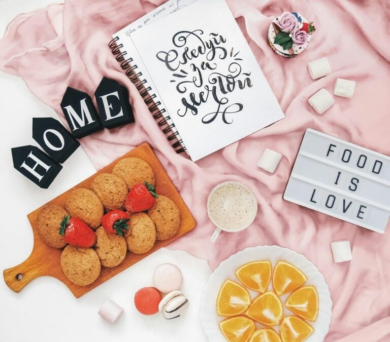 Cookies, fruit, and marshmallows with "food is love" sign