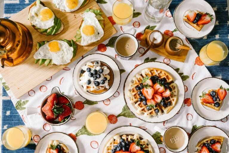 breakfast spread with waffles eggs and juice