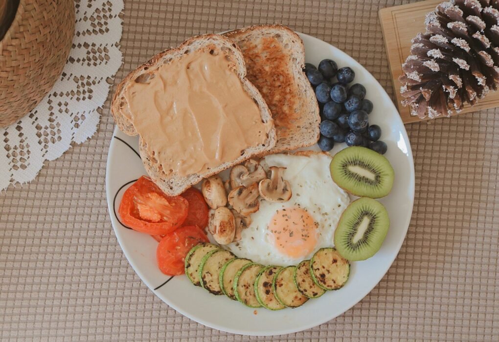 bread with sliced fruits on white ceramic plate