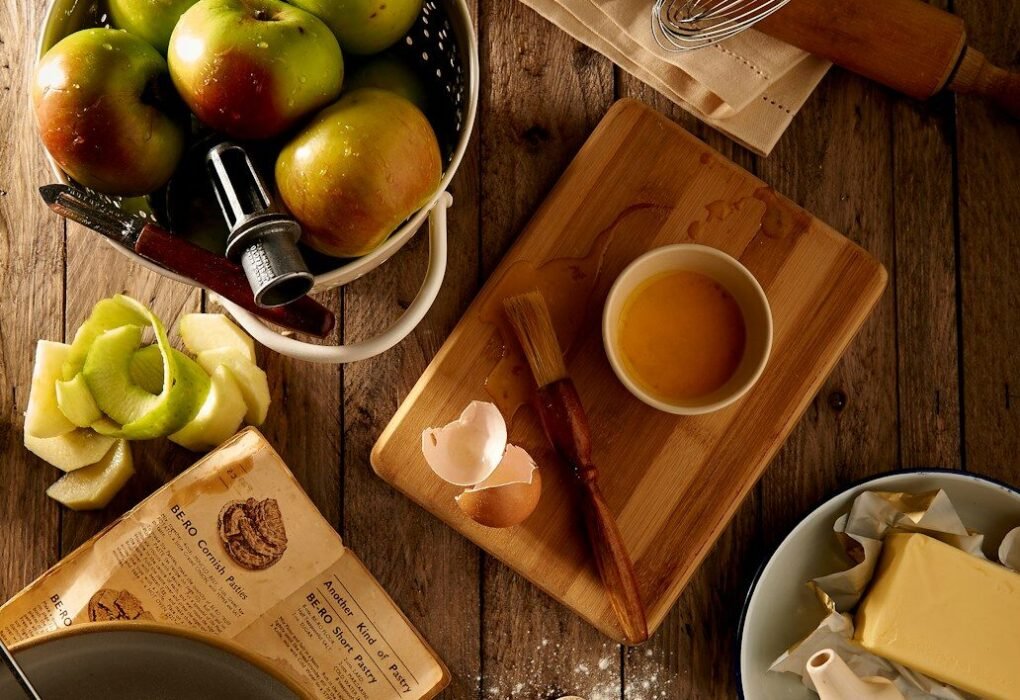 flat lay photography of mug on brown wooden chopping board